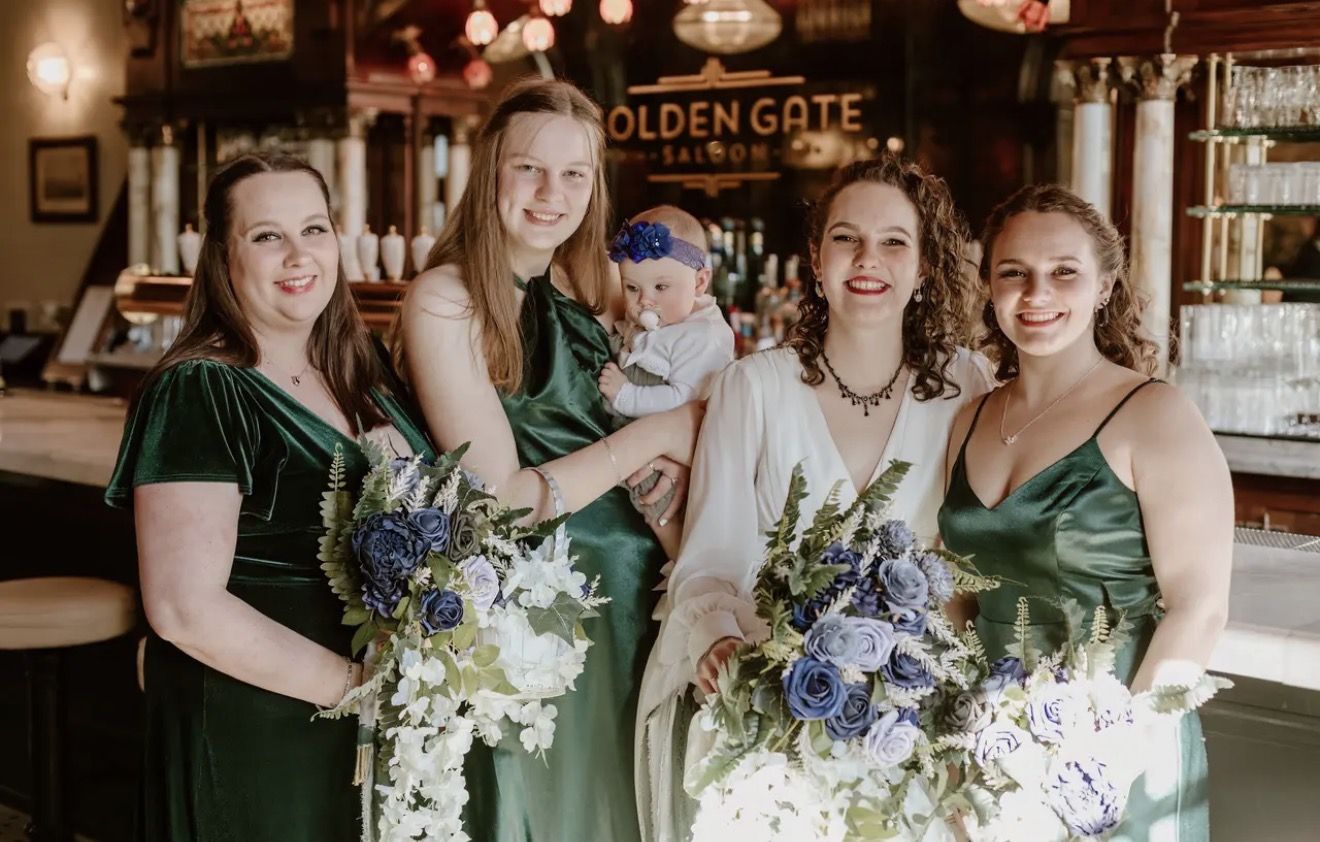 Bridesmaids in green gathered at a hotel bar